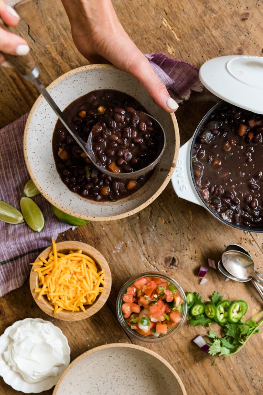 serving easy black bean soup into bowl