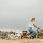 Woman riding bike outside.