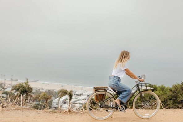 Woman riding bike outside.