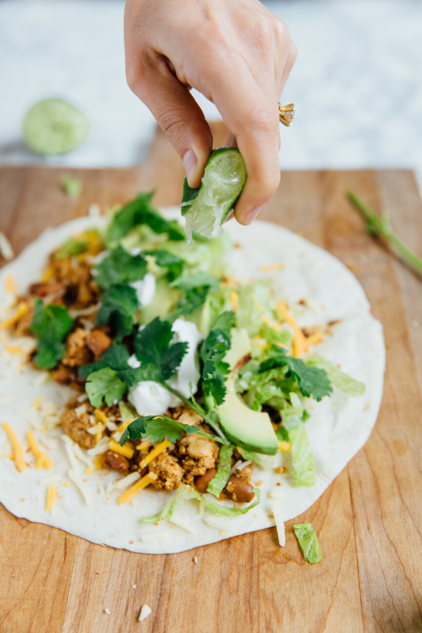 squeezing lime on vegetarian breakfast burrito