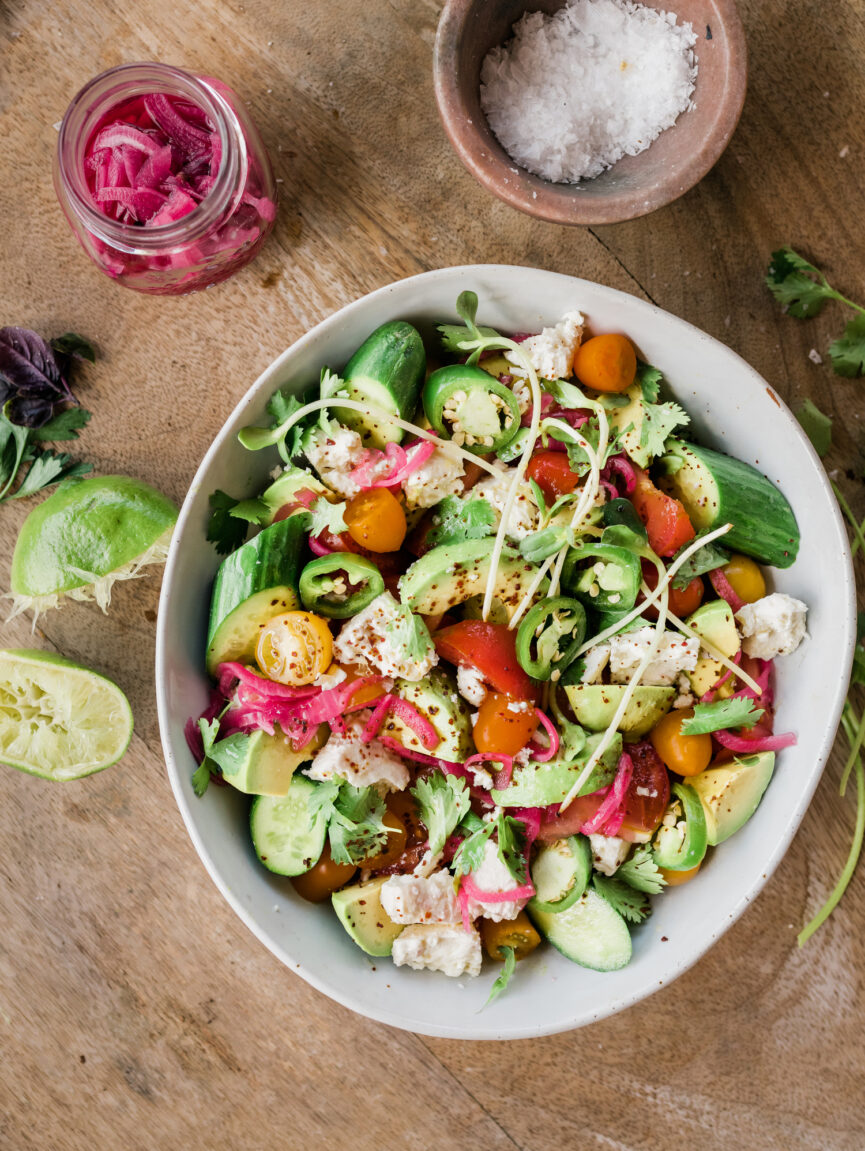 tomato, avocado, and cucumber salad assembled