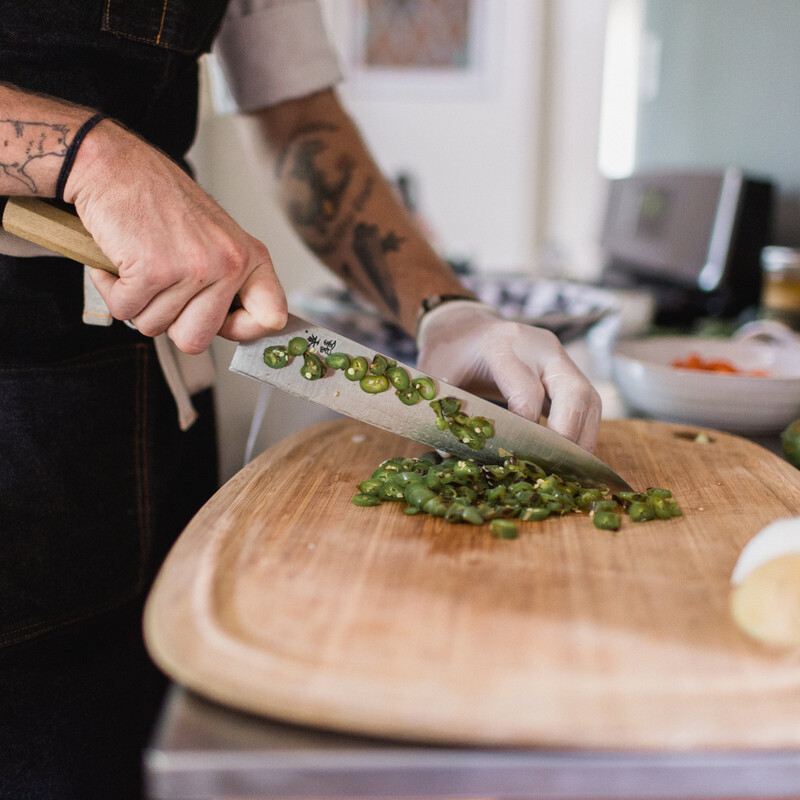 chef chopping with tattoo
