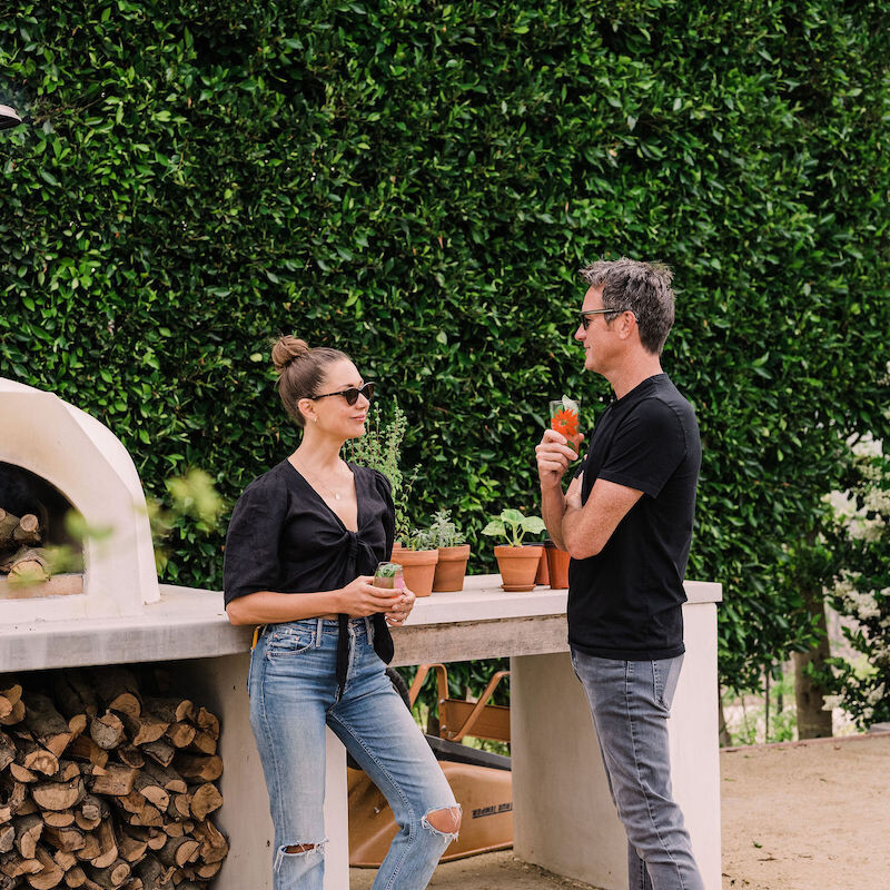 beautiful backyard at sunset with covered terrace and pizza oven - helene henderson home - malibu farm - couple - camille and adam - date - romance