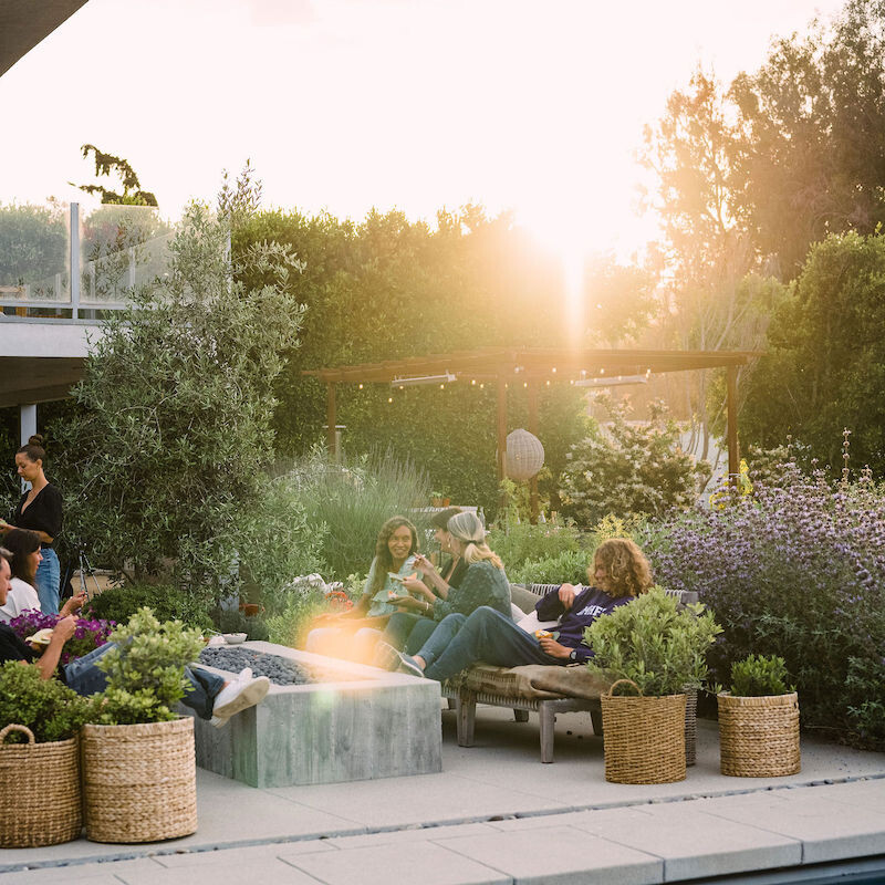 summer dinner party - beautiful backyard at sunset with covered terrace and pizza oven - helene henderson home - malibu farm