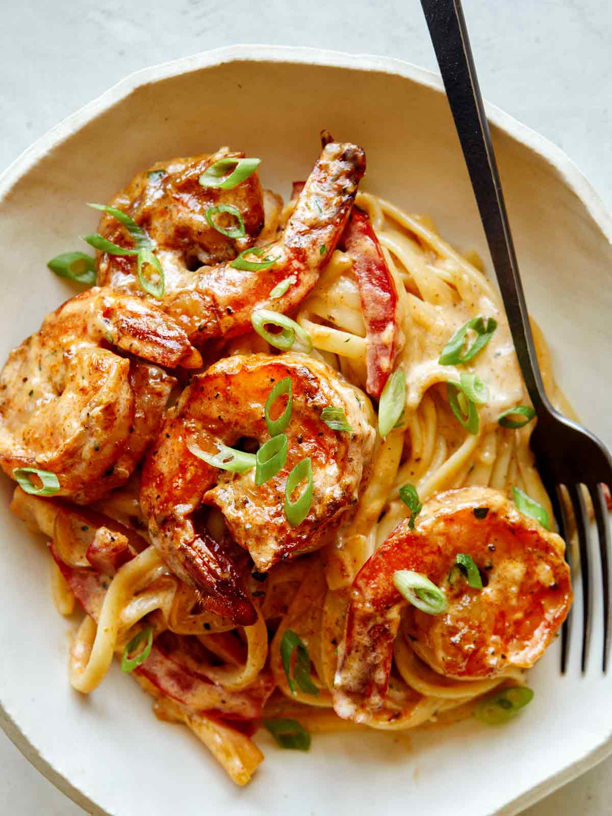 cajun shrimp pasta from spoon fork bacon