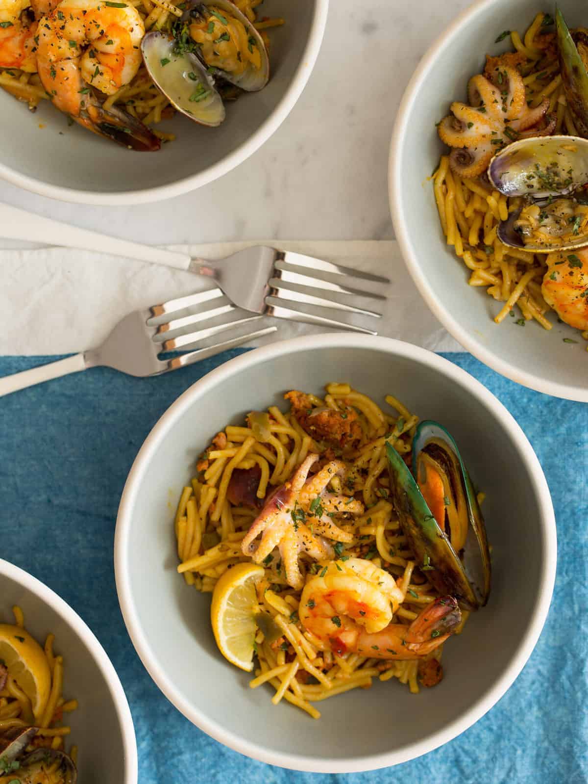 seafood fideua from spoon fork bacon