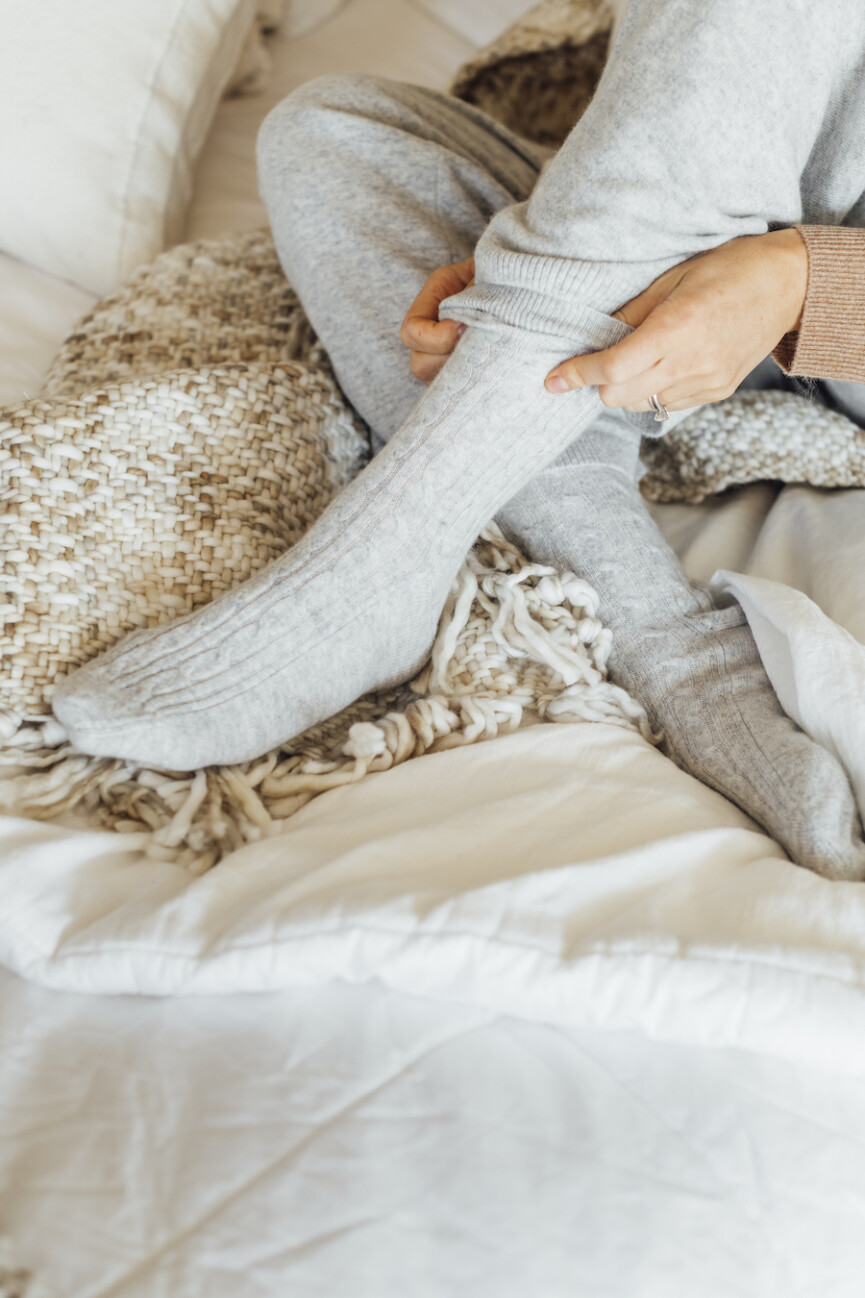 camille in bed, blanket, sheets, bedroom, rest, sleep, socks