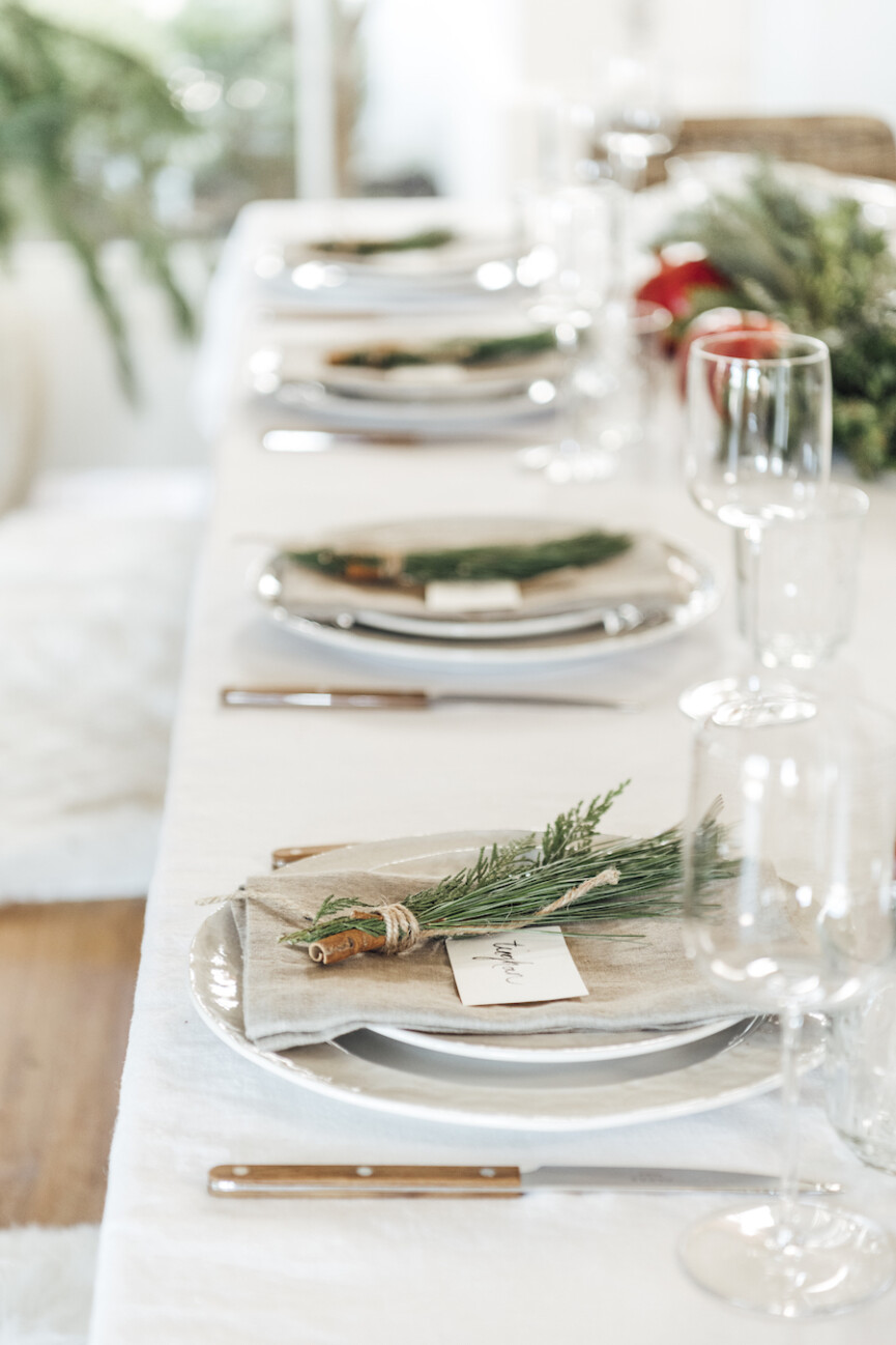 simple christmas table setting ideas-scandinavian inspired holiday tabletop with evergreen and pomegranates-camille setting table