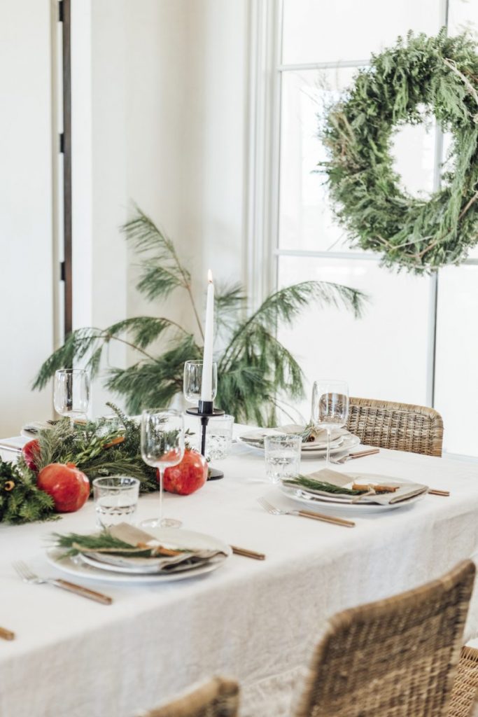 Hygee-inspired table with pomegranates and natural greenery