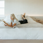Woman reading feel-good book in bed.