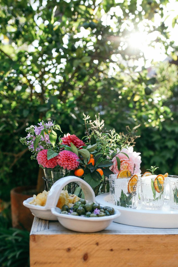 Dinner party set-up with bouquets, drinks, and appetizers at Valerie Rice's dinner party in Santa Barbara_how to grow your own food