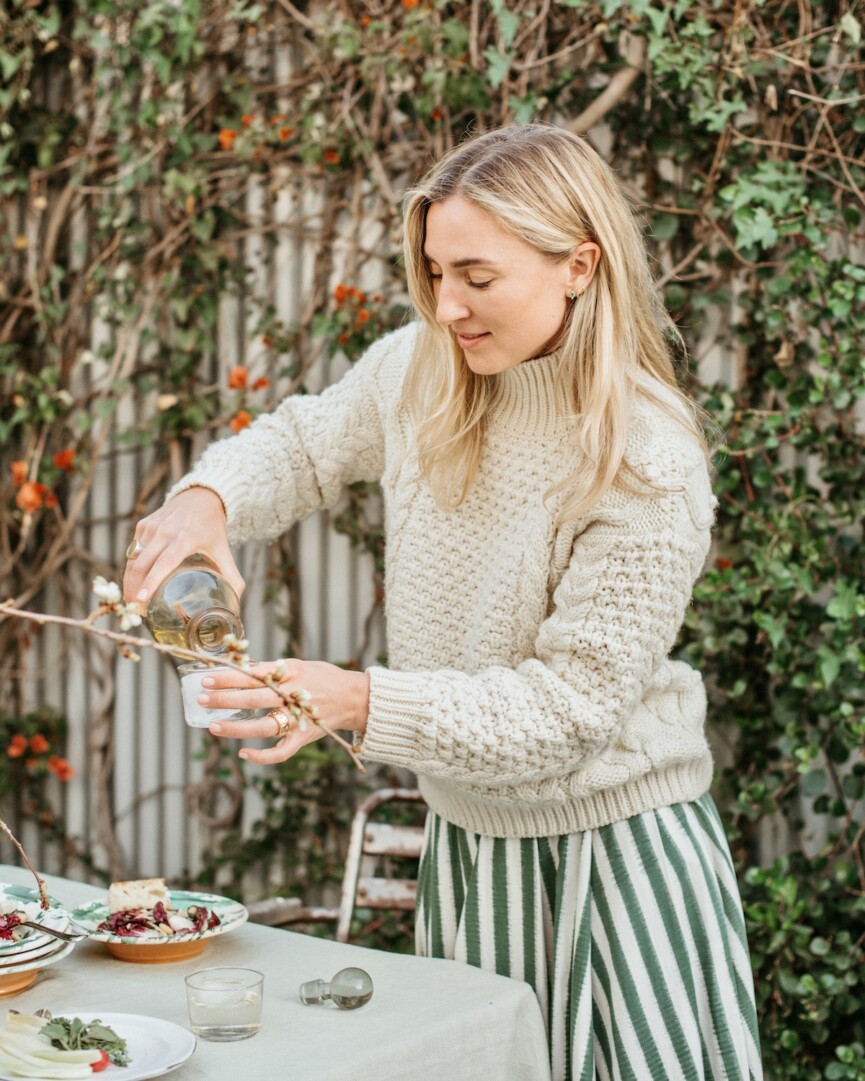 olivia muniak making cocktails, negronis, spring summer dinner party in backyard