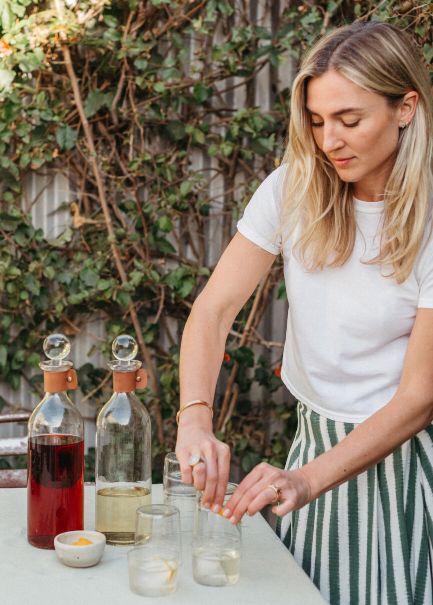olivia muniak making cocktails, negronis, spring summer dinner party in backyard