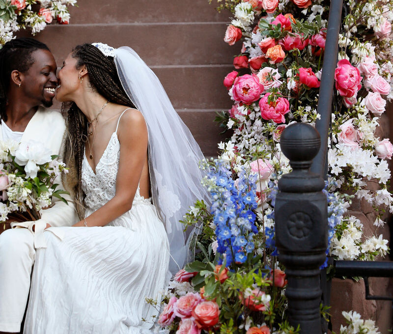 bride and groom amidst flowers