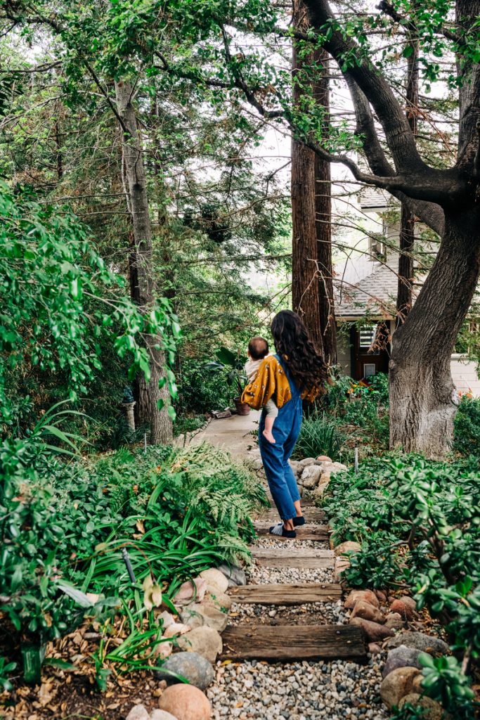 Kimberly Snyder holding baby walking through backyard_how to shift career