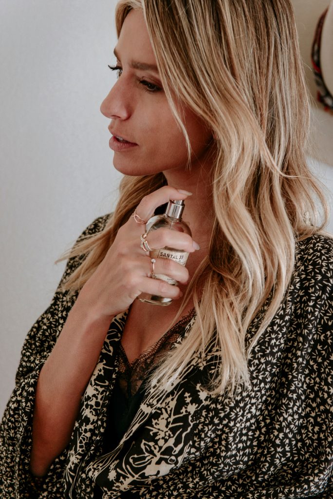 Woman spraying le labo perfume.