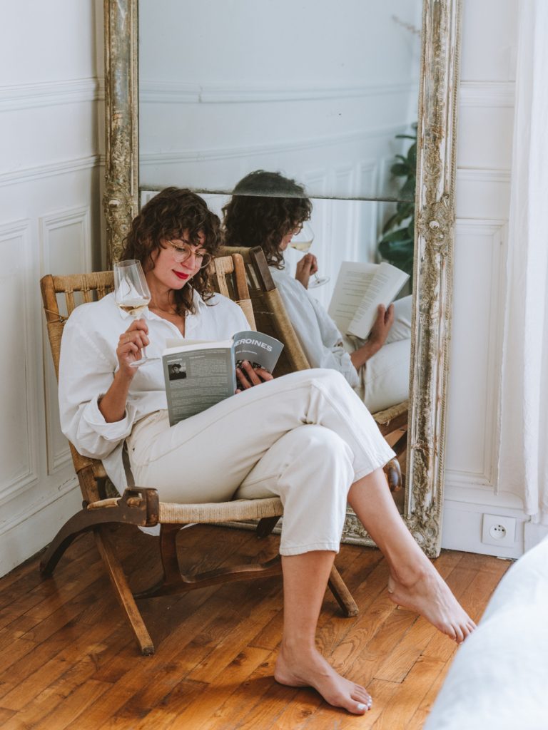 Rebecca Peppler reading with a glass of wine_the best books to read in your 30s