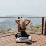 Blonde woman meditating on deck_how often should you poop