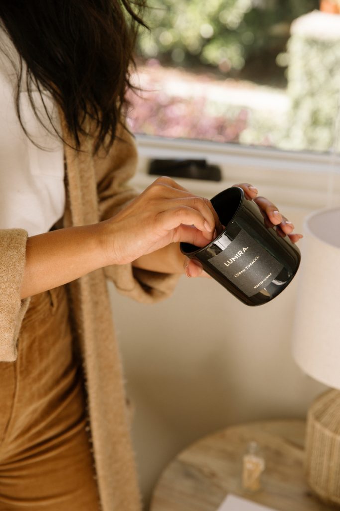 woman lighting candle_best fall candles