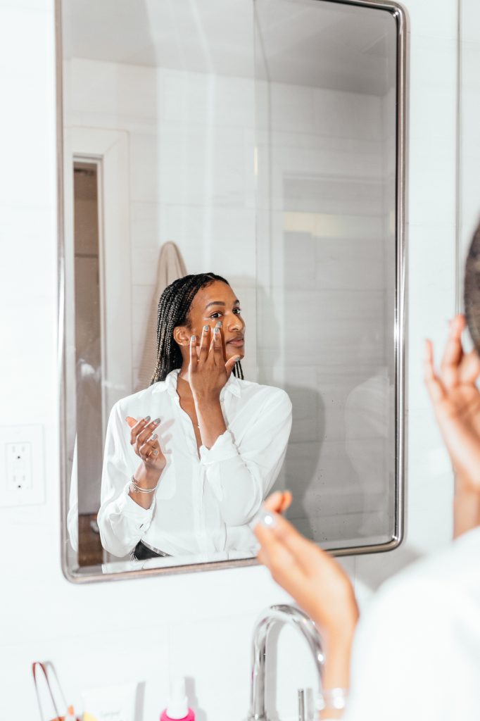 Shanika Hillocks applying skincare_how to repair sun-damaged skin