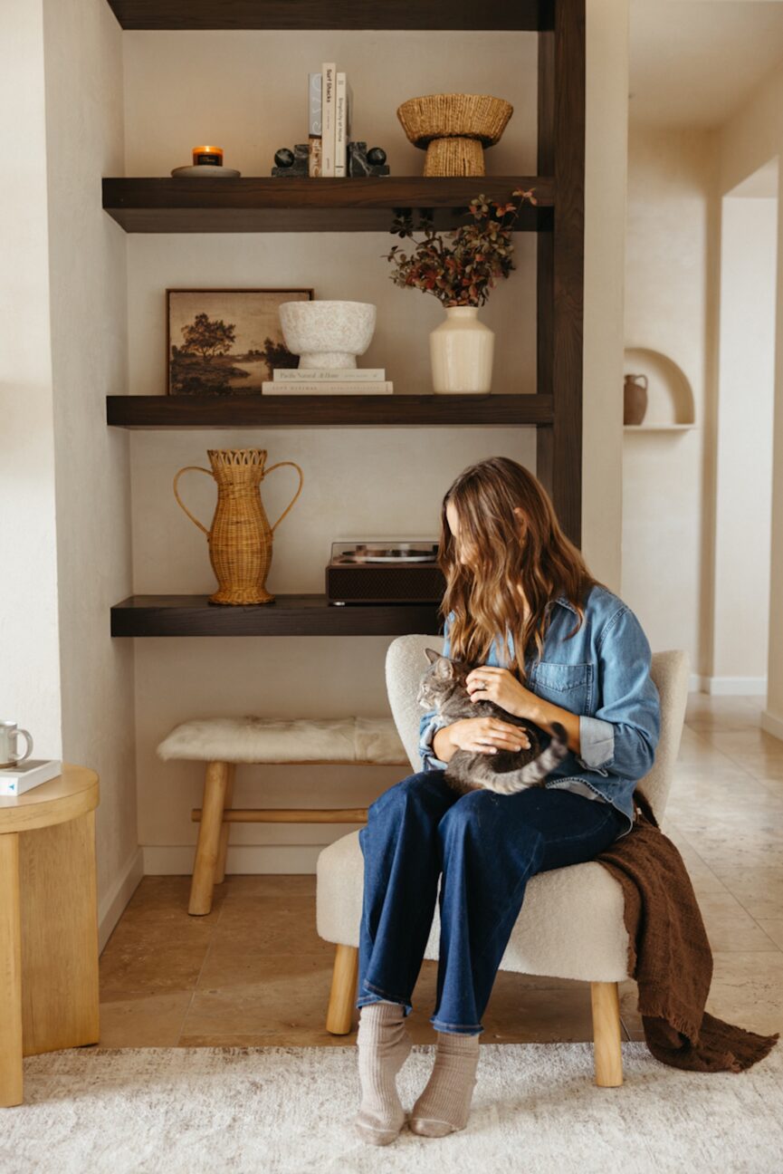 Woman snuggling cat.