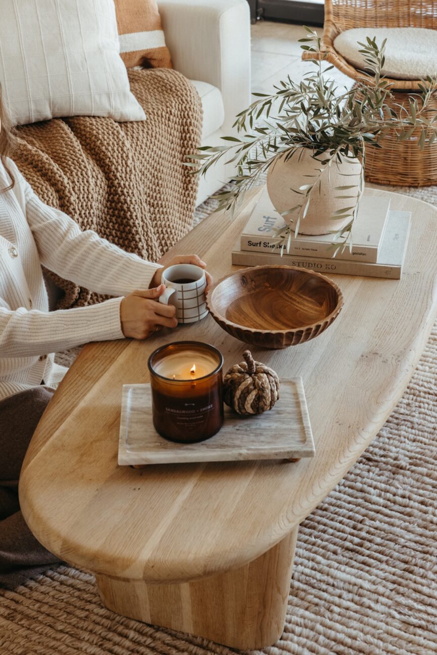 Woman drinking tea at coffee table