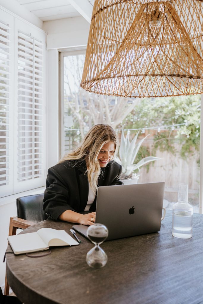 Janessa Leoné working at desk_best neck creams
