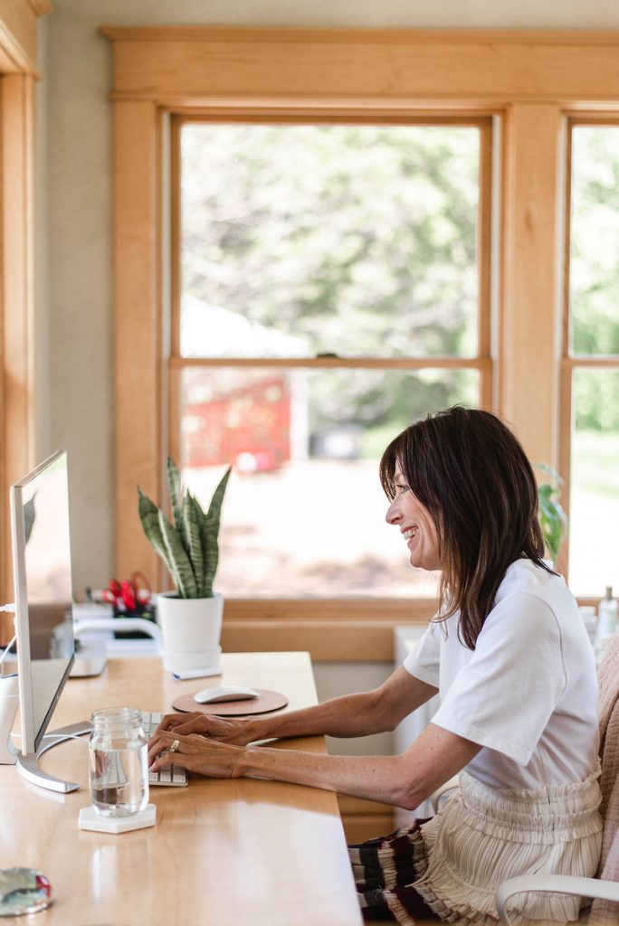 Sally Mueller working at desk at home_best neck creams