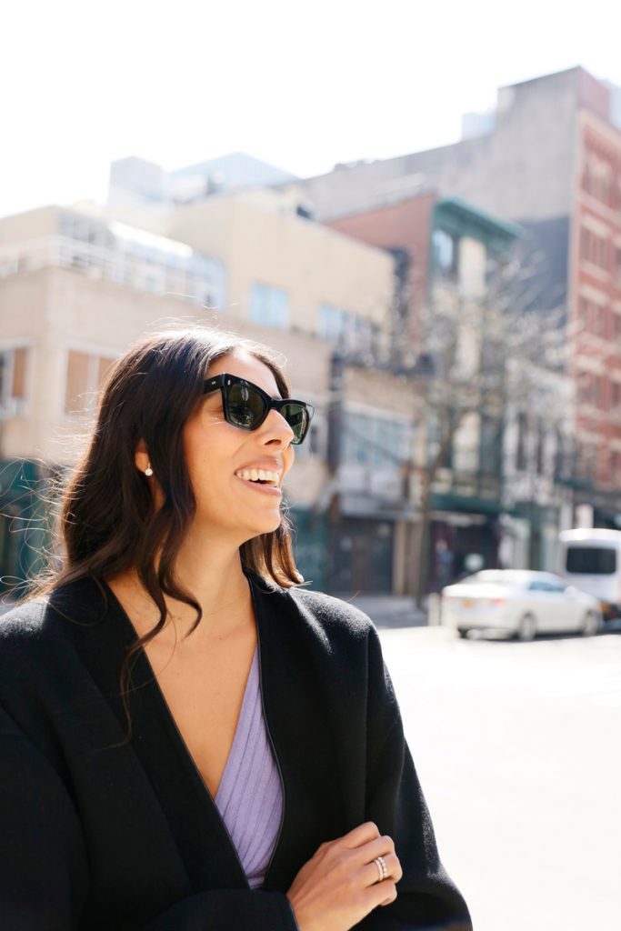 Babba Rivera smiling wearing sunglasses outside