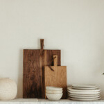 casa zuma stack of handmade wabi sabi plates and cutting board on open shelf