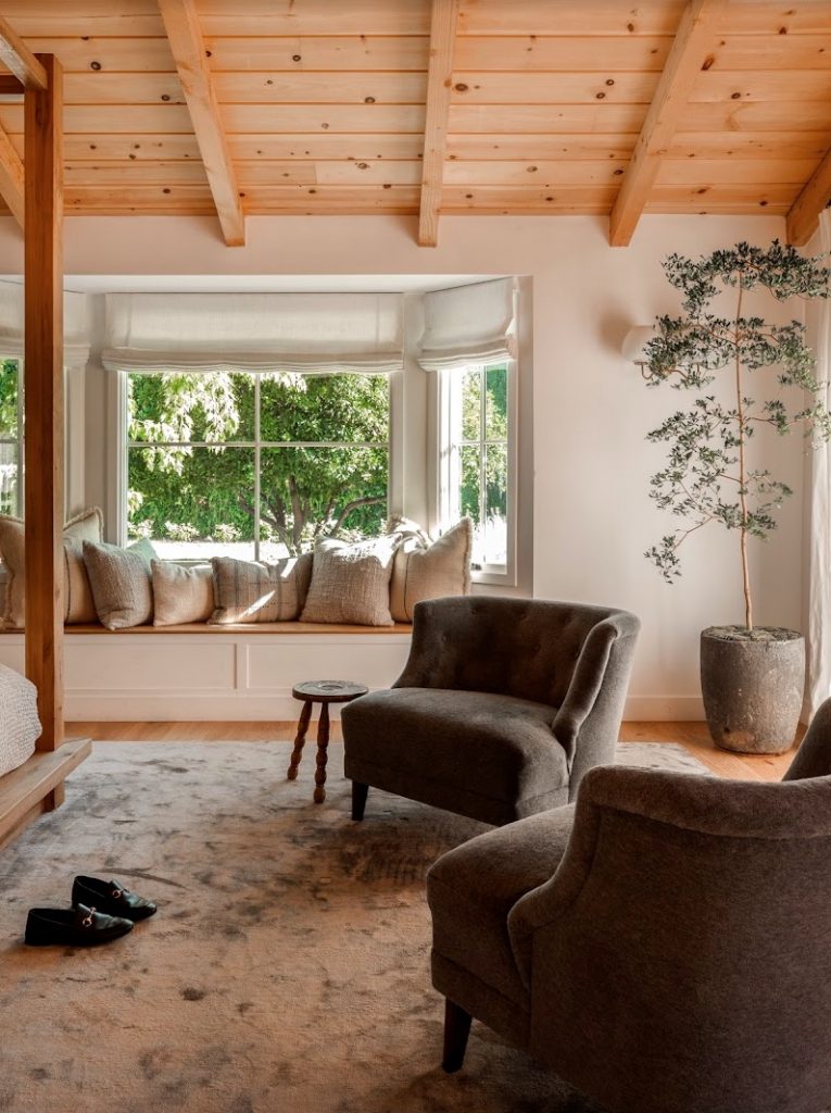 bright airy bedroom with accent chairs