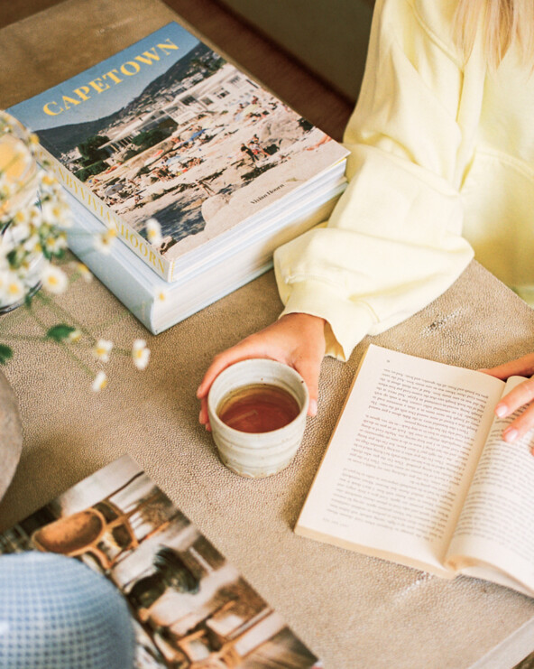 Woman drinking coffee reading.
