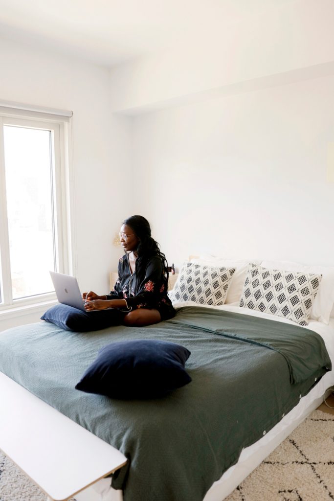 Marie Kouadio Amouzame working in bed_overwhelmed at work