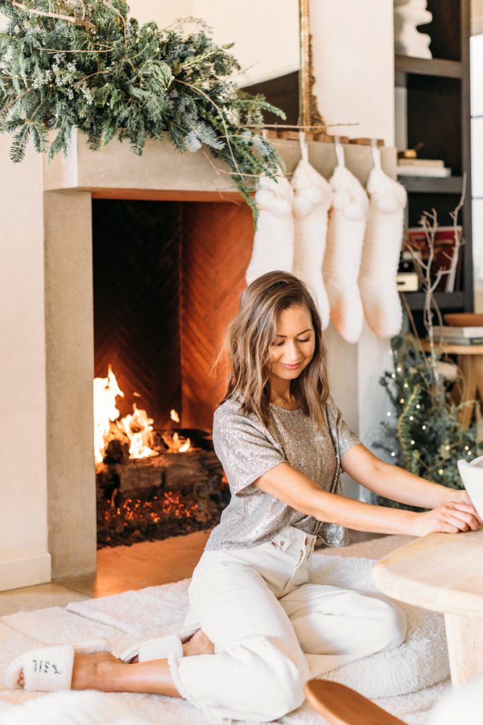 camille sitting by christmas fireplace