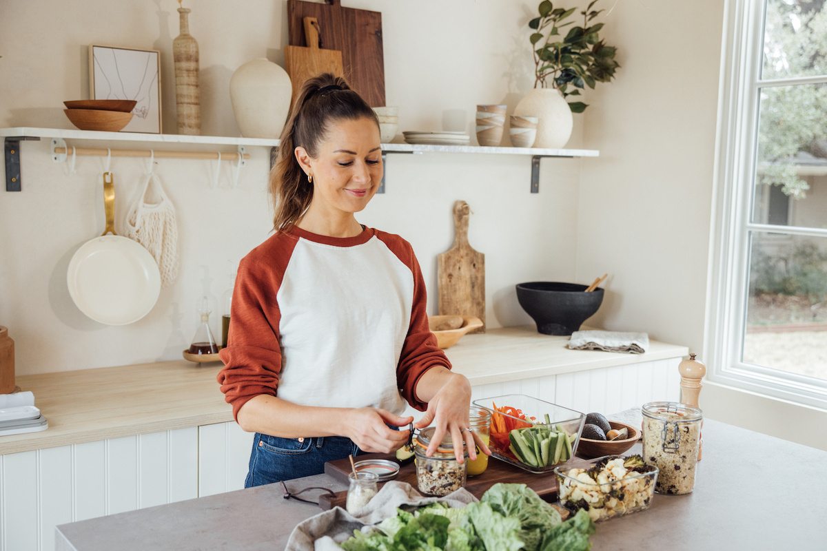 Camille Styles doing meal prep in kitchen_postpartum nutrition