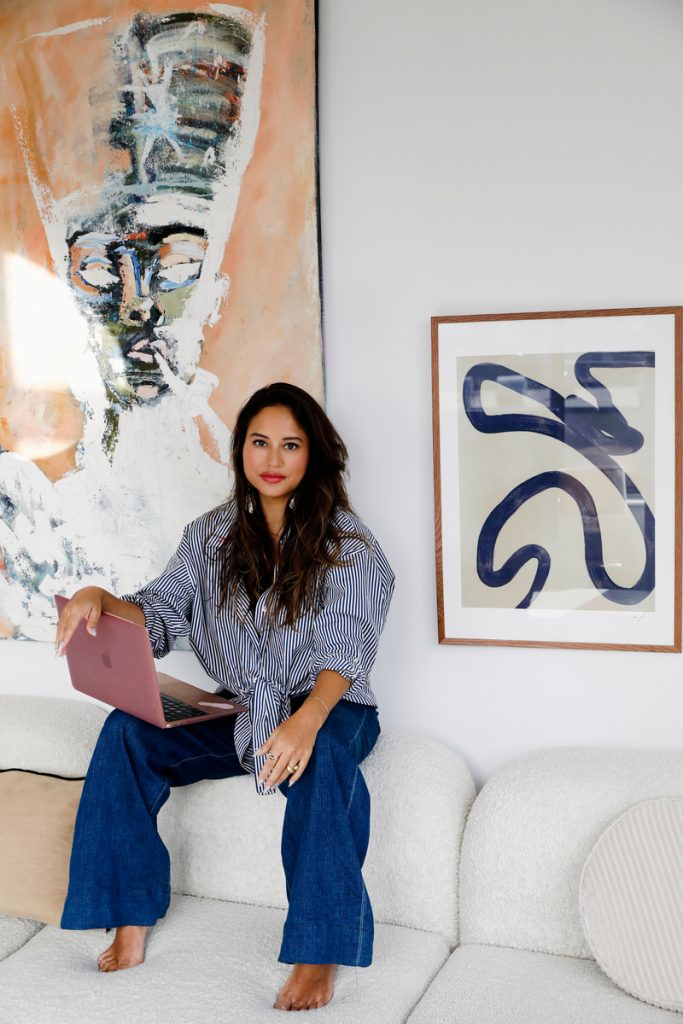 woman sitting on couch with laptop