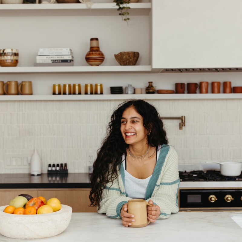 Radhi Devlukia-Shetty drinking tea in kitchen.