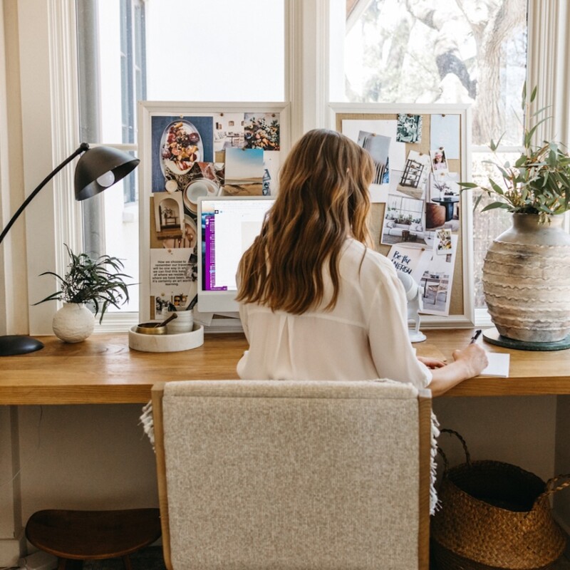 Camille Styles writing at desk