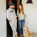 Love languages, explained. Image is a couple standing in a doorway with their dog.