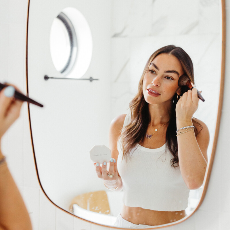 Woman applying makeup.