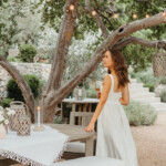 Camille Styles wearing white dress.