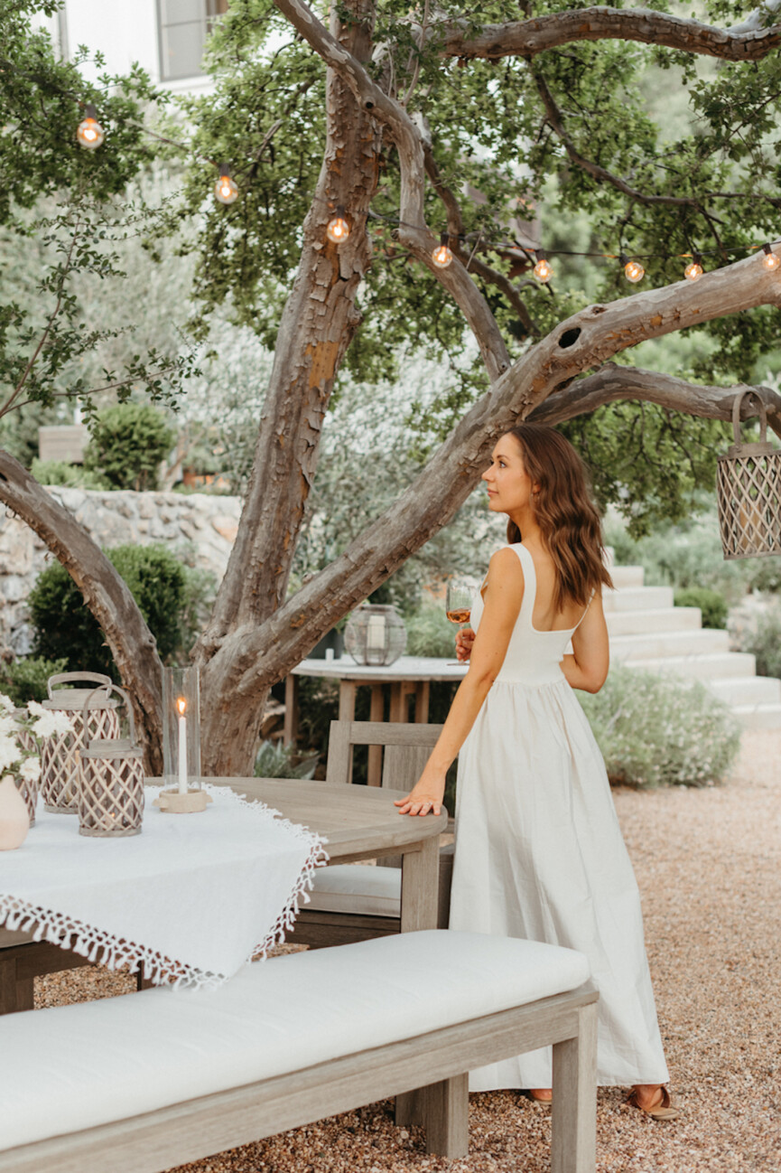 Camille Styles wearing white dress.