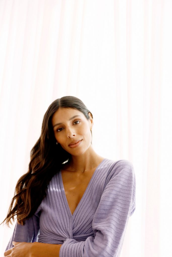 Babba Rivera wearing lavender sweater dress.