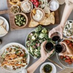 blood sugar travel tips-cheersing, food, dinner party