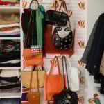 closet clean out with organized purses on the wall