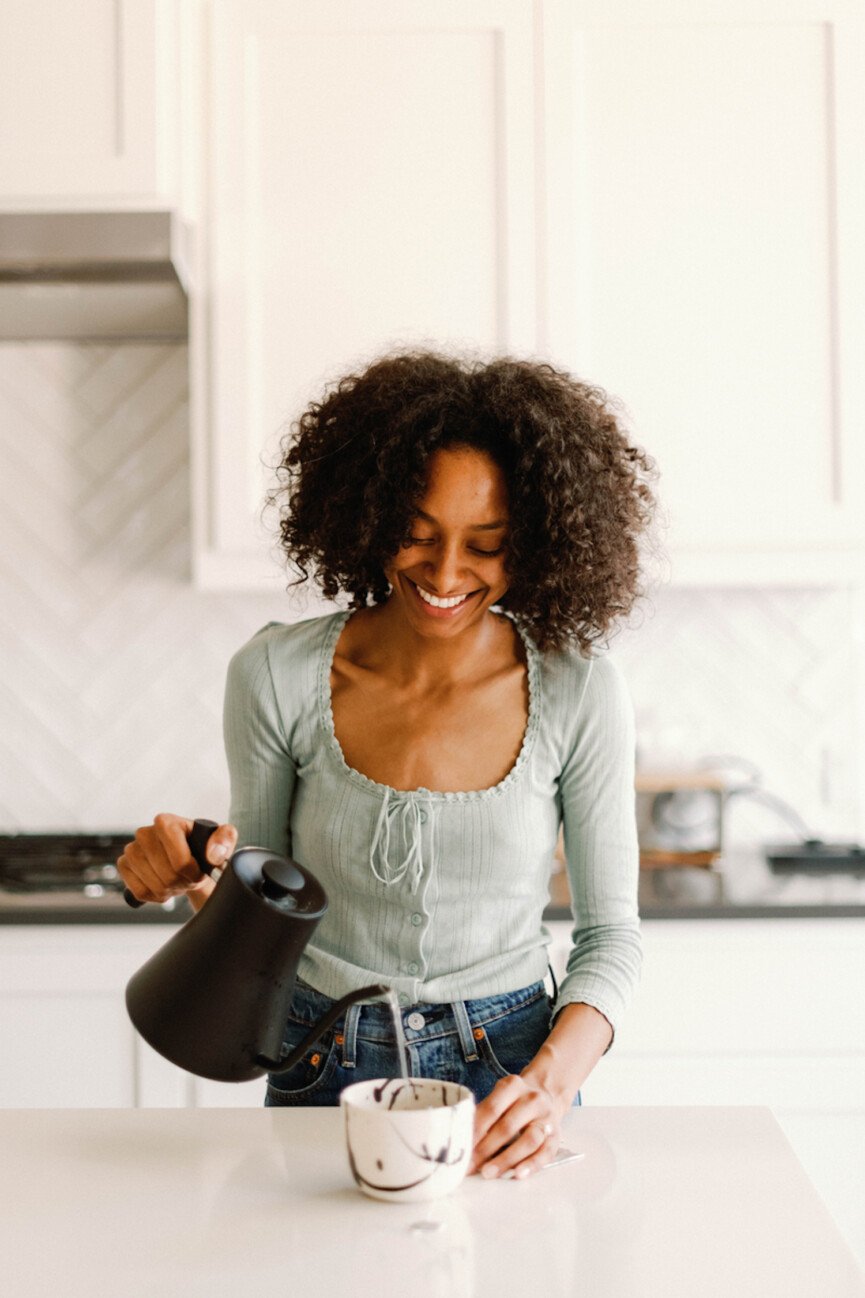 Woman brewing best tea for digestion_best fall drinks