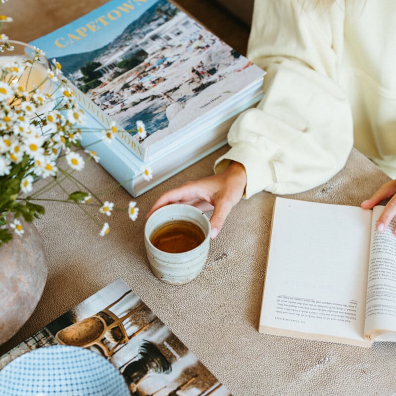 Woman reading drinking tea.