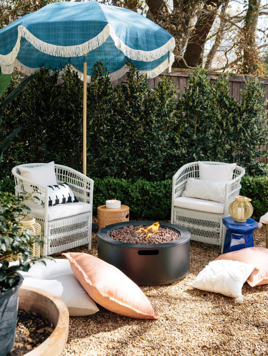 Small backyard landscaping ideas with gravel, small chairs and a fire pit