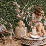 Woman sitting on outdoor chairs.