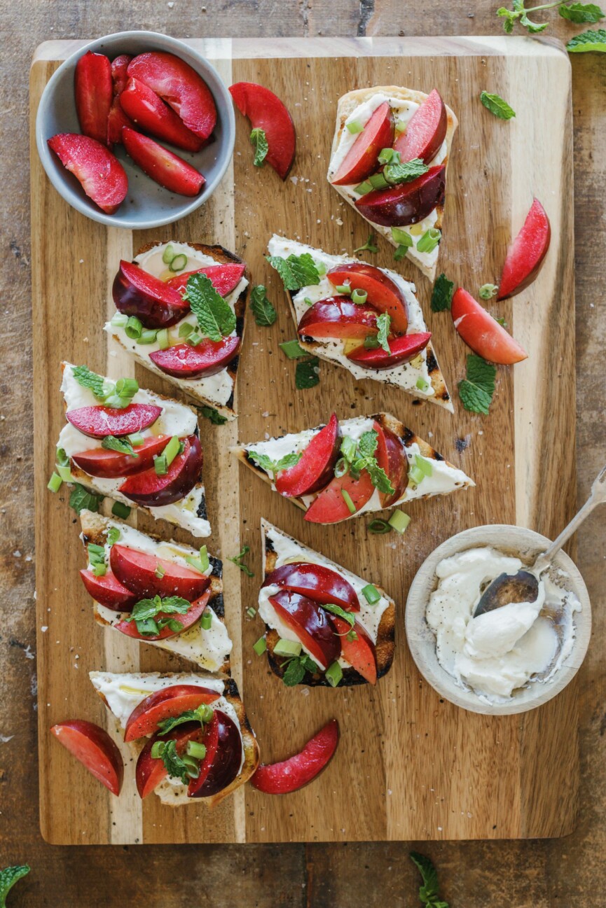 ricotta and plum bruschetta on serving board